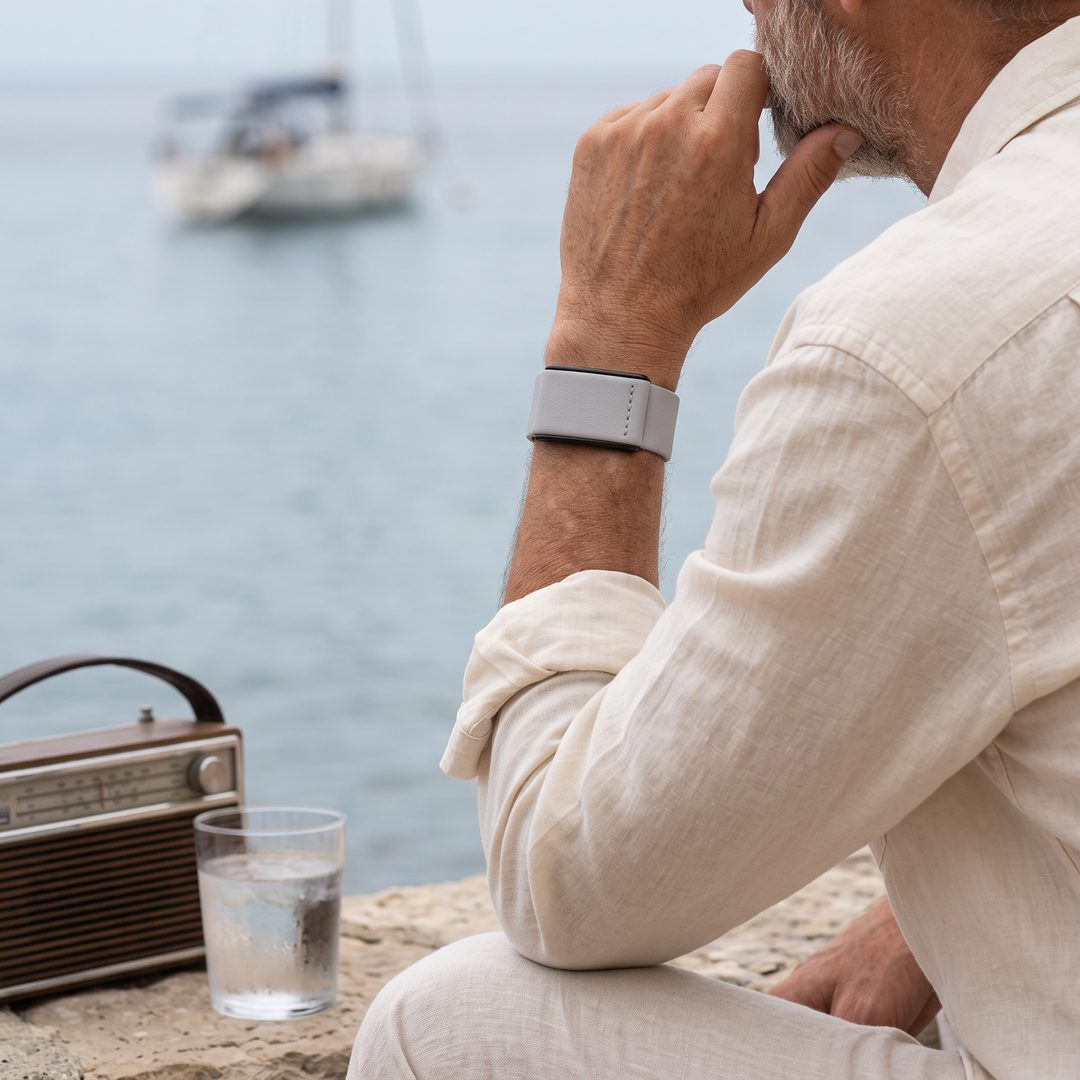 Ecoband 5.0 in Cloud worn with a linen shirt, looking out to sea (cloud)