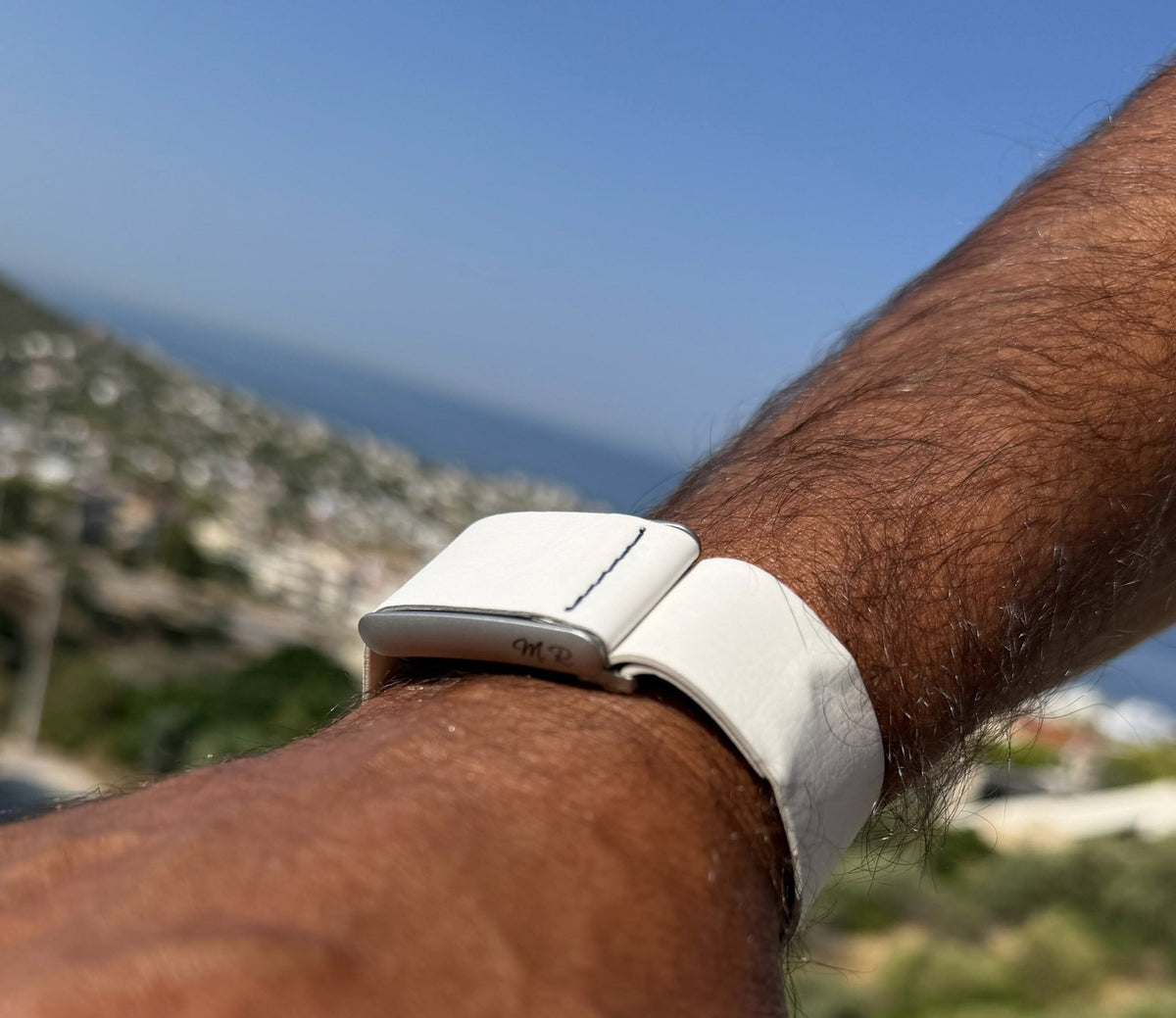 Rocker Duck Ecoband in White with engraved initials, worn on the coast