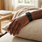 Ecoband 5.0 in Black on the wrist — handmade Italian bio-leather WHOOP band, relaxing at home (black)