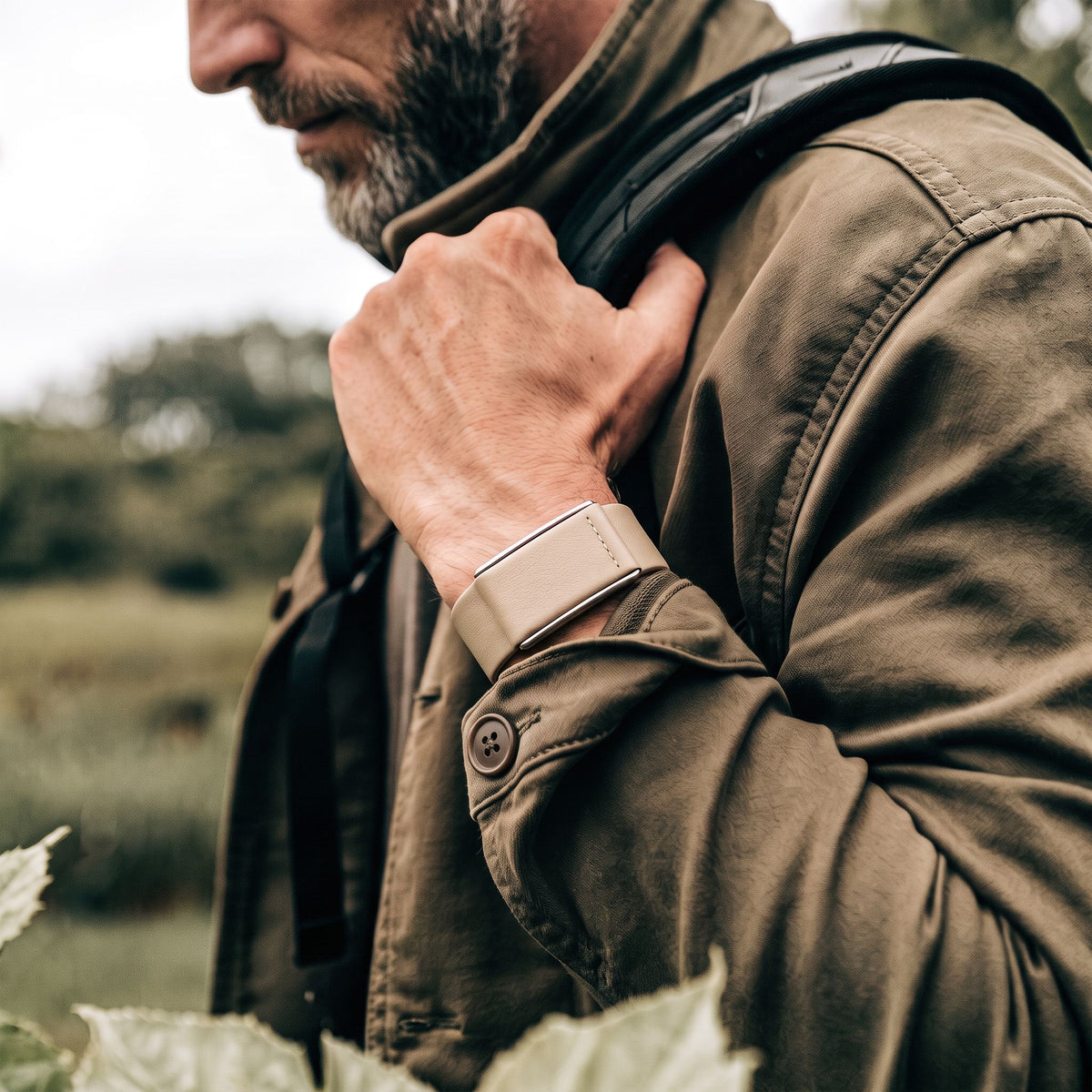Ecoband 5.0 in Sand worn with a field jacket on a country walk (Sand)