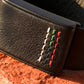 Ecoband 5.0 Roots in UAE Flag — black bio-leather WHOOP band with hand stitching in the UAE flag colours, on red rock (UAE Flag)