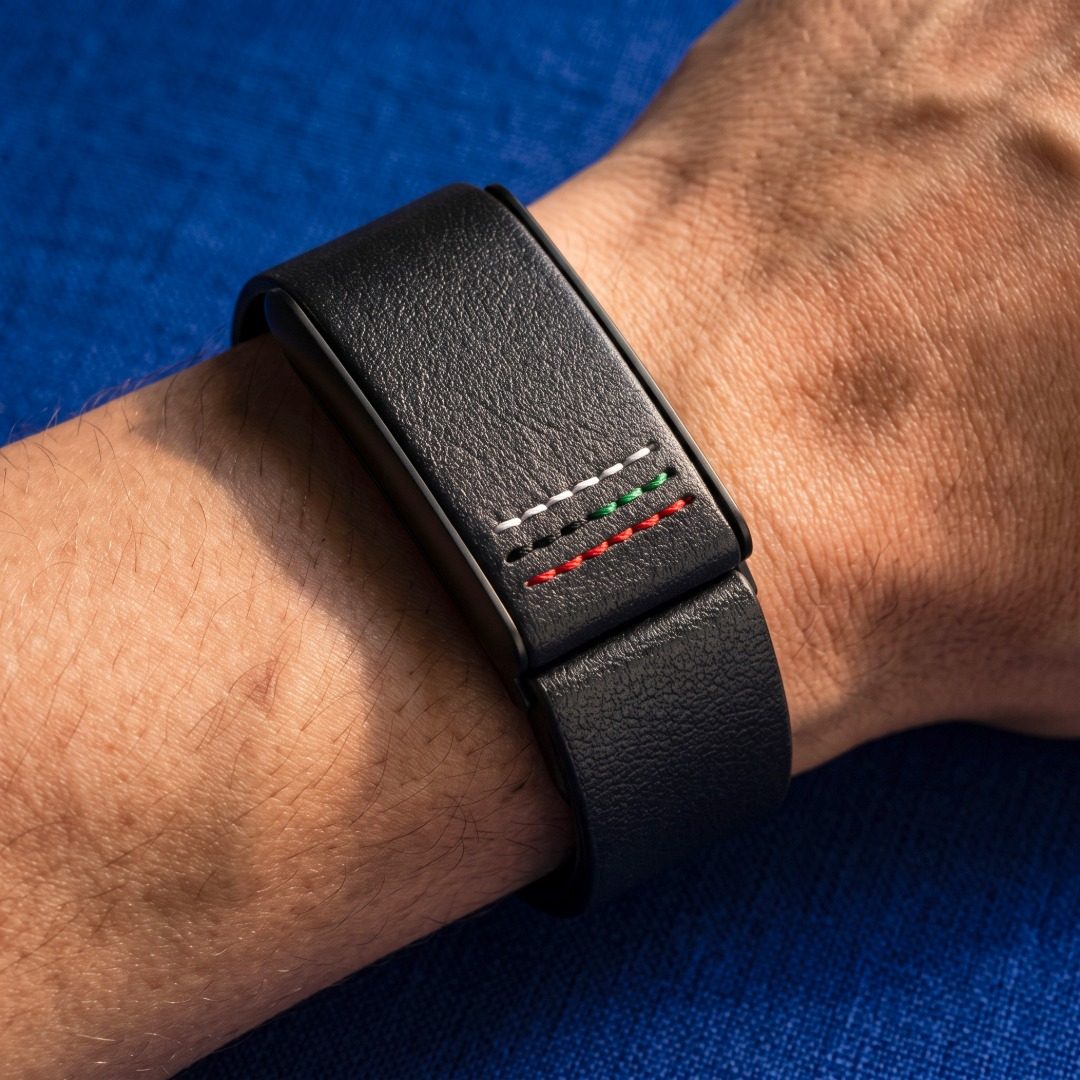 Ecoband 5.0 Roots in UAE Flag worn on the wrist, on blue linen (UAE Flag)